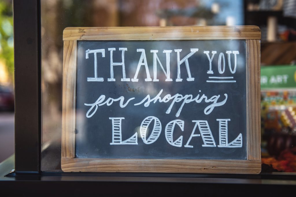 sign in window saying "thank you for shopping local"