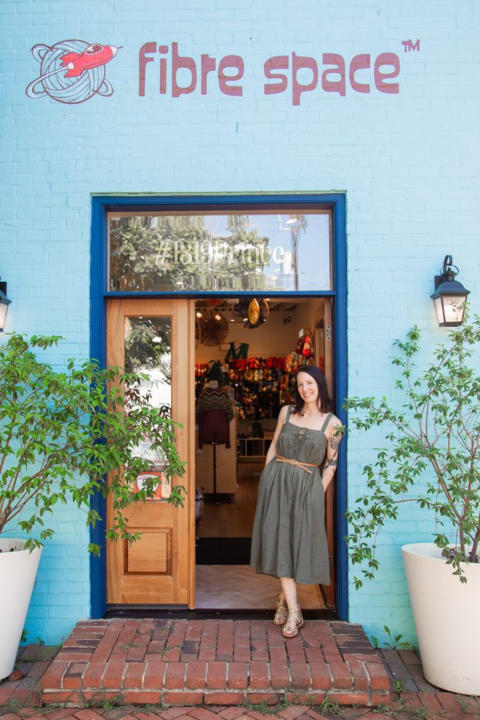 owner danielle romanetti standing in the doorframe of her business, fibre space