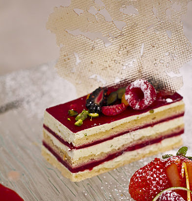 Picture of layered cake topped with raspberries
